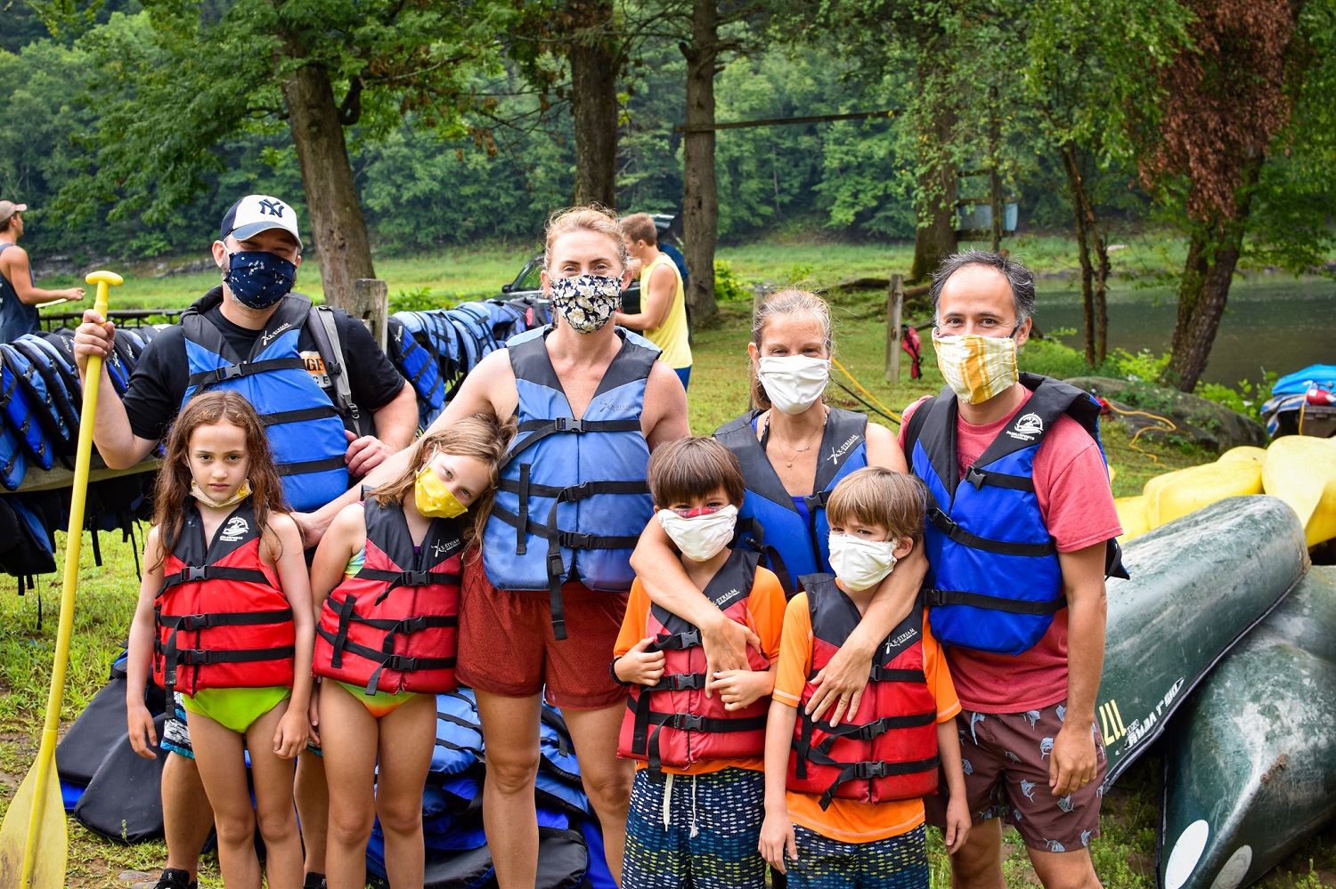 family in life jackets ready for rafting trip