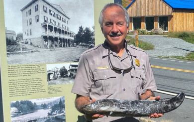 Don Hamilton, of the NPS, smiling while holding a frozen Snakehead Fish