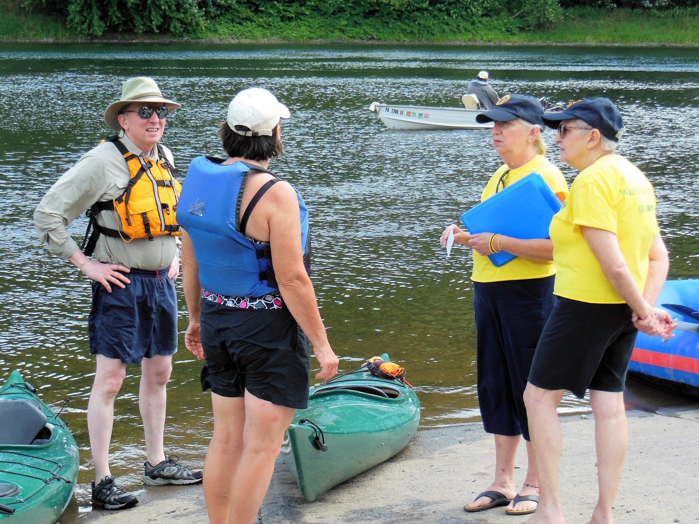 a group of kayakers discussing the conditions of the River