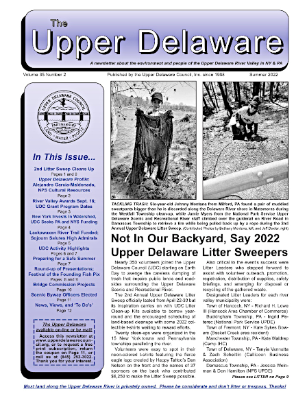 Cover of the Summer 2022 Upper Delaware Newsletter, featuring a photo of a six-year old with a huge pair of muddle sweatpants he found during a litter sweep, and a woman beyond a guide rail in a Litter Sweep t-shirt picking up trash