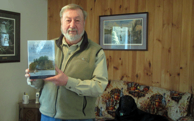 Lee Hartman holding his book The Delaware River Story: Water Wars, Trout Tales, and a River Reborn